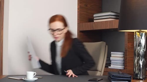Young Concentrated Woman, Sitting in Her Room or Office