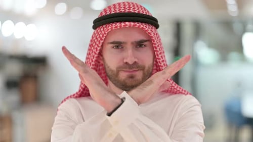 Middle Eastern Young Adult Shows Refusal Sign