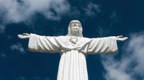 Religious Statue Against a Cloudy Blue Sky