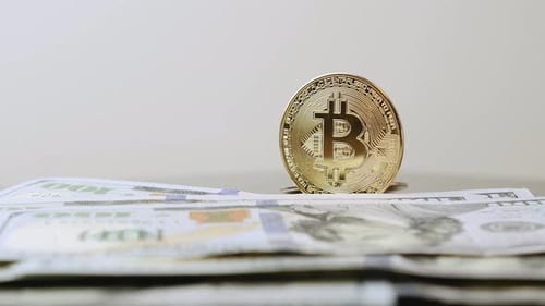 Close Up of Bitcoins and One Hundred Dollar Bills