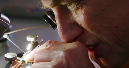 Close-up of horologist using a machine
