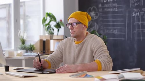 Middle-Aged Designer Working on Computer in Office