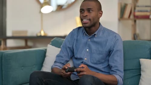 Man Playing Video Game, Celebrating Achievement