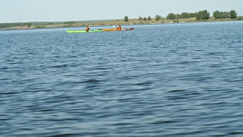 Two Kayakers Rowing on Lake