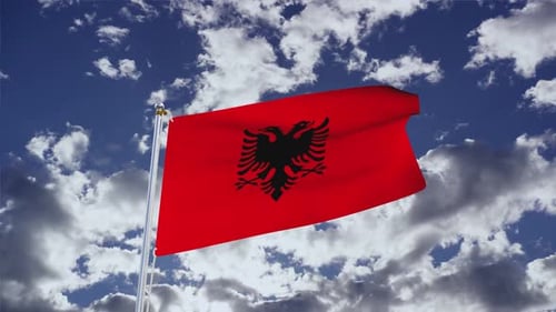 Albanian Flag Waving Proudly Against Blue Sky
