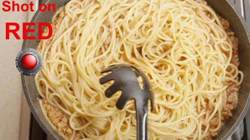 Pasta Being Added to Sauce and Stirred