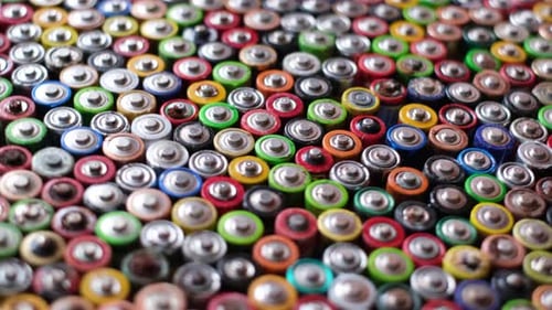 Background with Used Batteries Folded in the Center Types AAA AA Top View