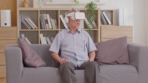 Senior Man Using VR Headset on Couch