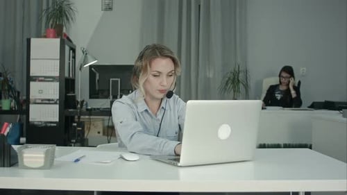 Customer Support Operator Working in a Call Center Office