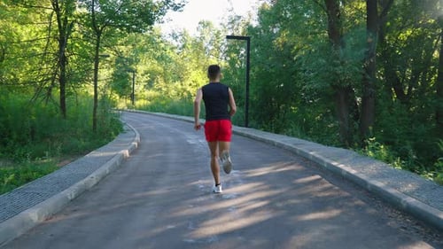 Slow Motion Man Jogging on Road