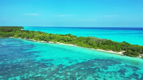 Wide angle above copy space shot of a paradise sunny white sand beach and aqua blue water background
