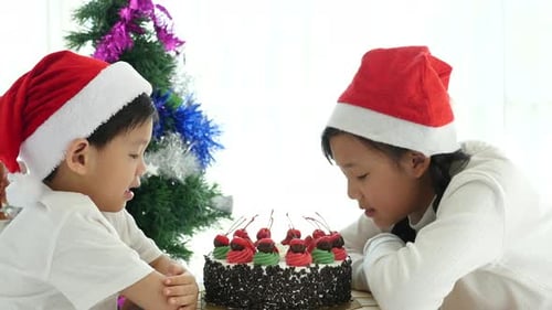 Kids Wearing Santa Hats Near Christmas Cake