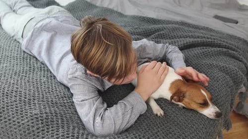 Boy Puts His Head on Dog While Lying Down