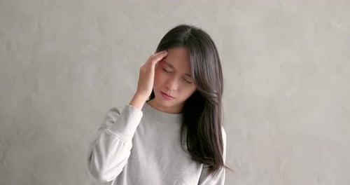 Asian woman feeling headache