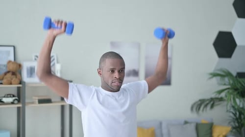 Close Up of Athletic African Man Exercising with Dumbbells