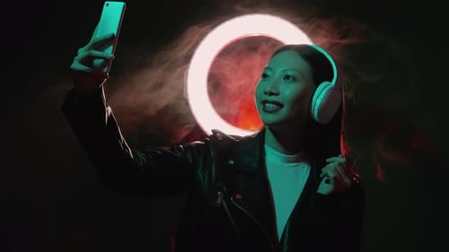 Stylish Woman Vlogging with Smartphone and Ring Light