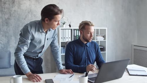 Two business persons are work together in modern office. Team of businessmen.