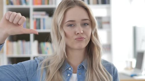 Thumbs Down By Young Woman in Office