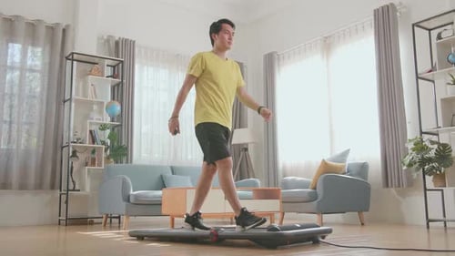Young Adult Walking on Treadmill in Living Room