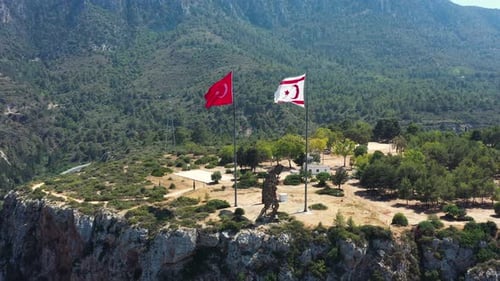 Scenic Landscape with Mountain Cliff and Waving Flags