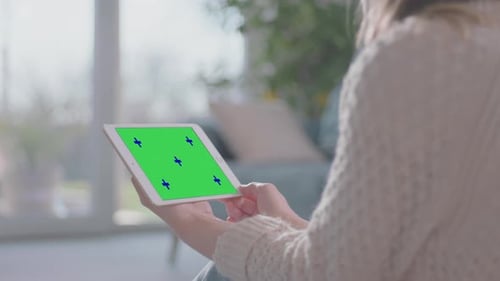 Woman Holds Tablet with Chroma Key in Bright Home