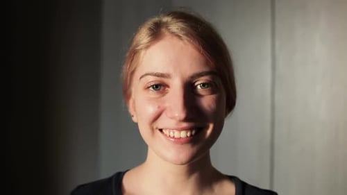 Smiling Woman's Portrait in Natural Light Indoors