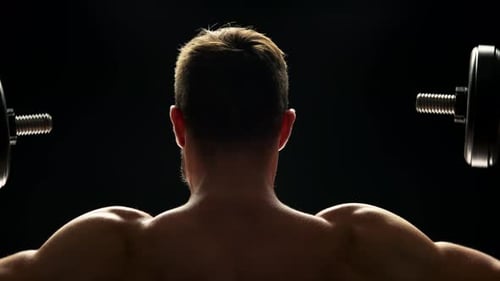 Close Up Muscular Man Lifting Dumbbells.