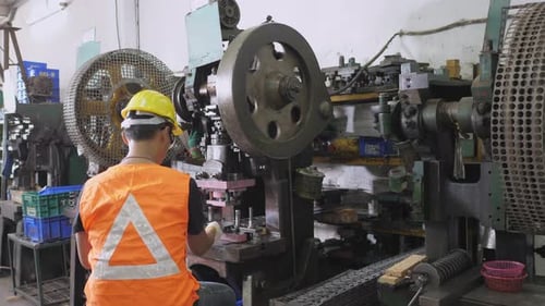 Factory Worker Operating Machinery