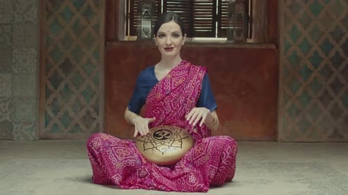 Woman Plays Handpan Drum Indoors