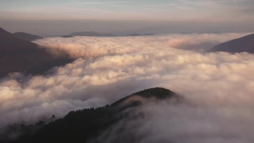 Mountains Shrouded in Clouds During Golden Hour