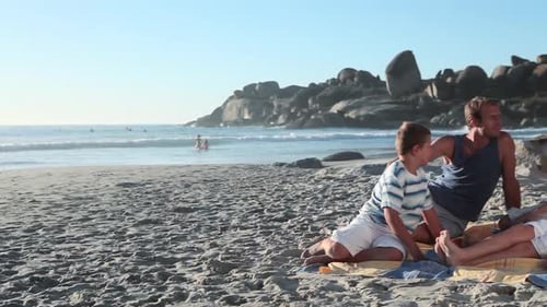 Family Sitting on Beach