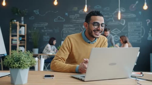 Smiling Man Talking in a Video Conference