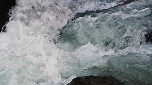 Close up of river stones with flowing water, clean water flowing in a mountain river