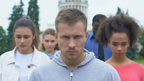 Diverse Group of Adults Looking Downcast in City