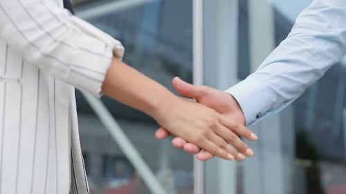 Business Handshake Outside Modern Glass Building