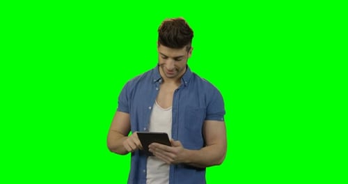 Man Using Tablet on Green Screen Background
