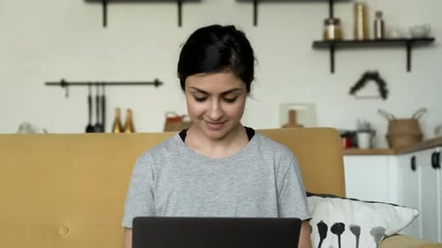 Close-Up Portrait of A Young Indian Woman Working on a Laptop, Doing Online Training or Business