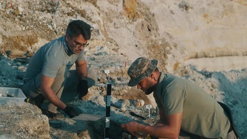 Archaeologist Excavating Ancient Necklace Together