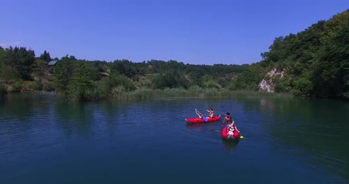 Aerial view of friends paddling canoe on river