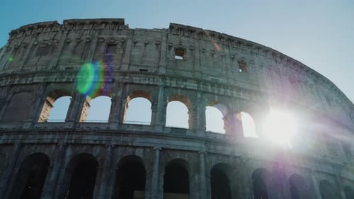 The Sun Shines Beautifully Through the Arches of the Colosseum in Rome. Steadicam Shot