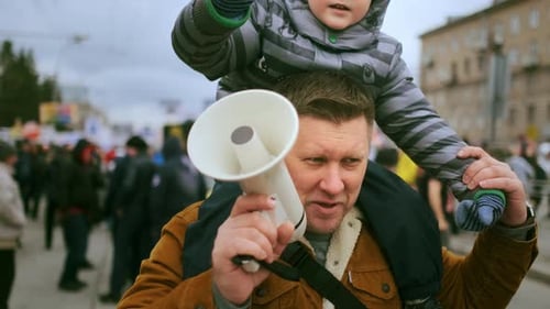 Adult with Child Speaking into Megaphone