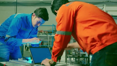 Engineers Working With Technology in Factory Workplace