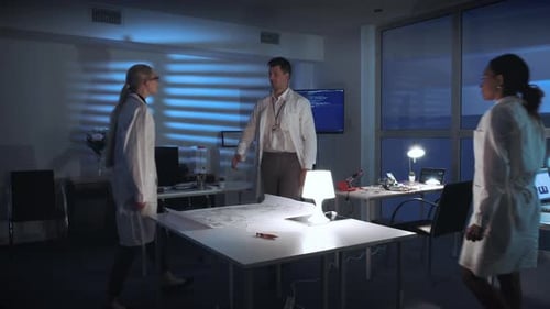 Scientists Collaborating on Blueprints in Modern Office