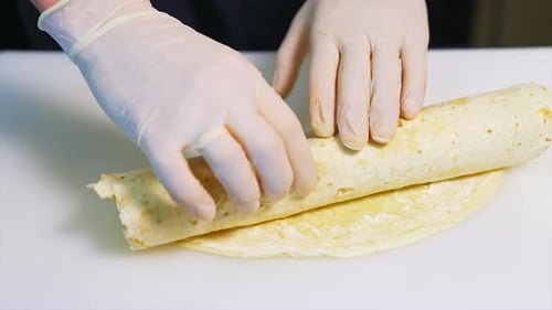 Hands Roll Tasty Tortilla Wrap on Counter
