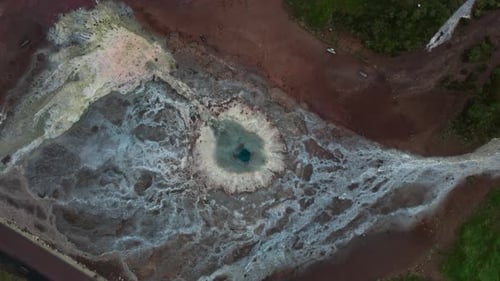 Drone Flight Over Geyser Pool And Surrounding Geothermal Landscape
