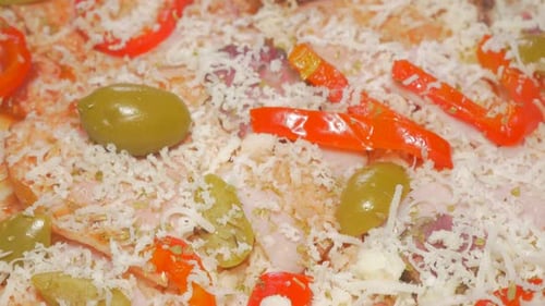 Tasty pizza base with spices and ham slow tilting 4K 2160p UHD video - Preparing pizza base while ti