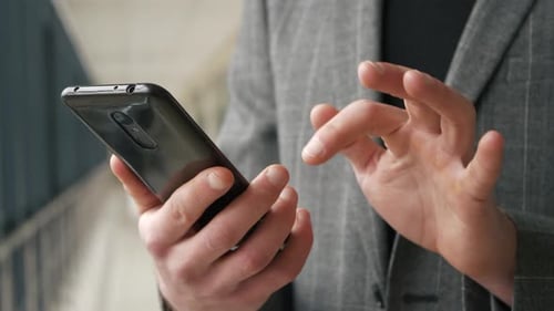 Man Using Smartphone Swiping in Close Up