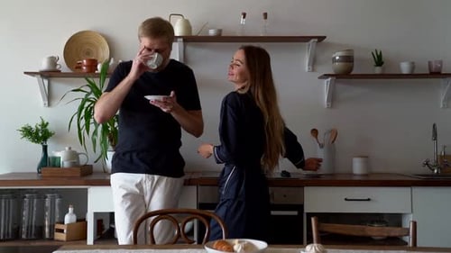 Couple Enjoying Morning Tea in Bright Kitchen