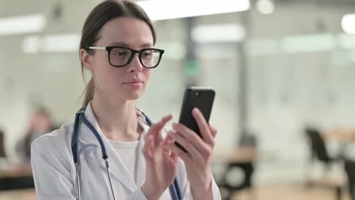 Female Doctor Using Smartphone in Office