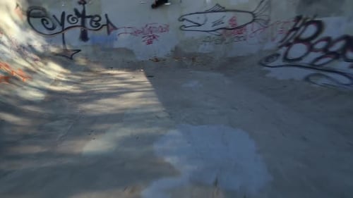 A young skateboarder skating in the bowl of a skate park.